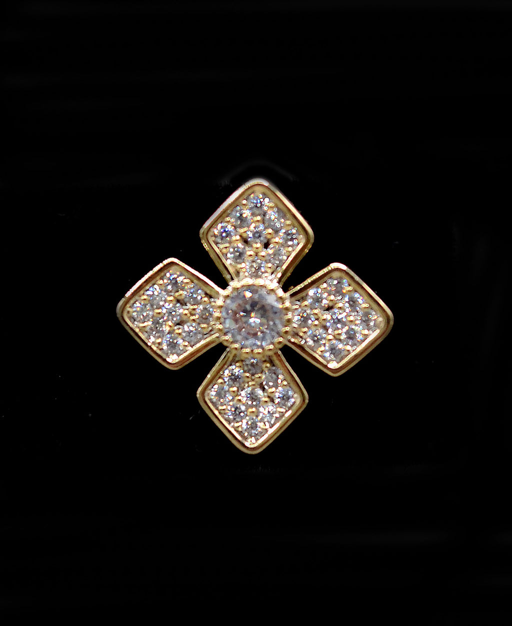 Geometric crystal clover studs featuring four square-cut stones arranged in a modern floral cross, detail view at Rebecca’s…