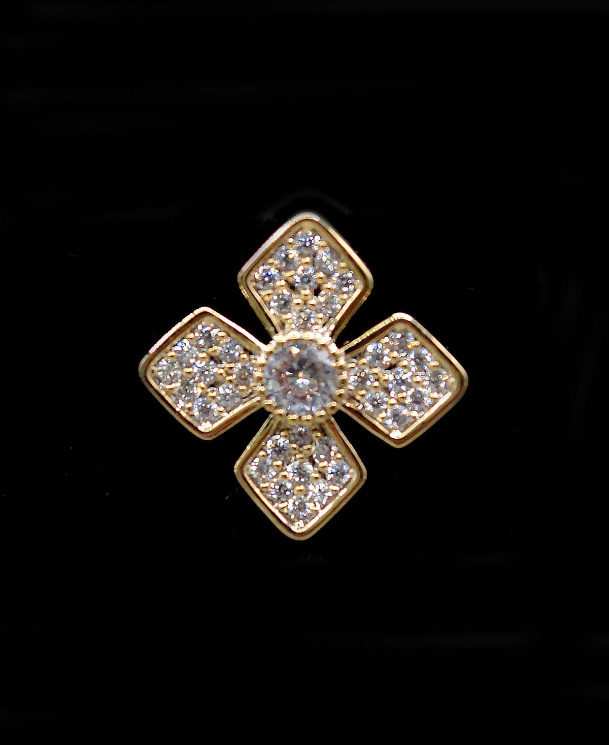 Geometric crystal clover studs featuring four square-cut stones arranged in a modern floral cross, detail view at Rebecca’s…