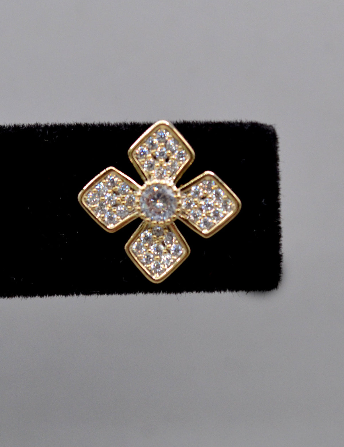 Geometric crystal clover studs featuring four square-cut stones arranged in a modern floral cross, view 4 at Rebecca’s…