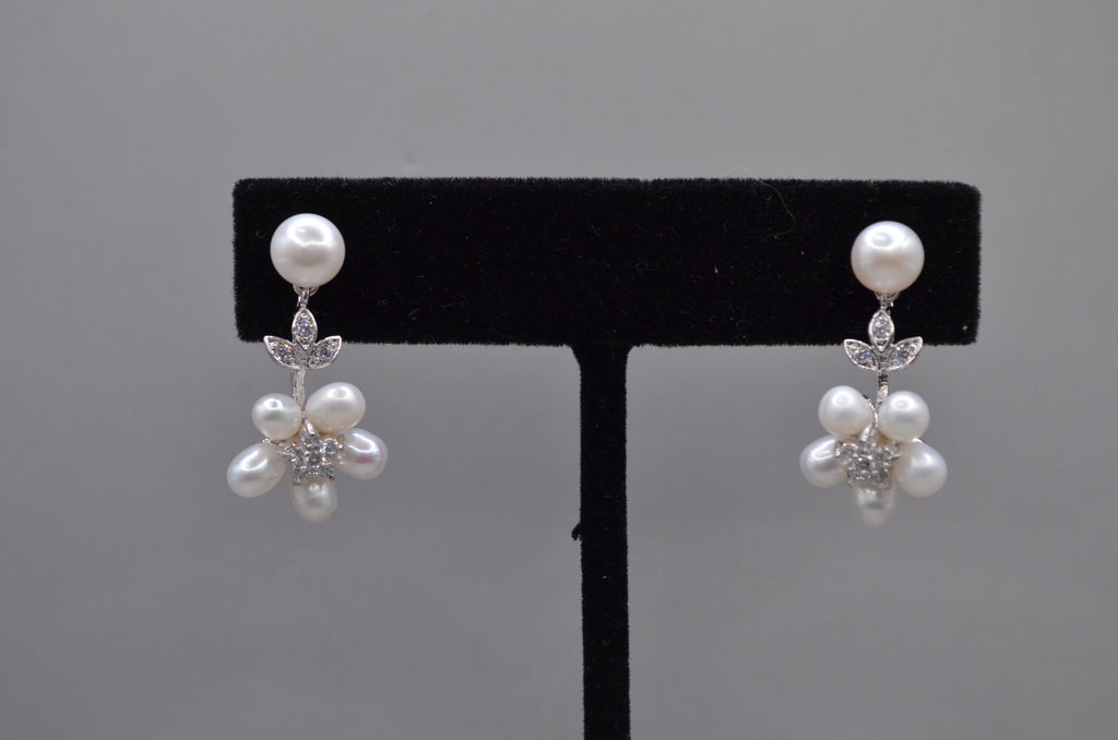 Pearl flower drop earrings featuring pearl stud with a delicate cluster of pearls and crystal leaves, alternate view at…