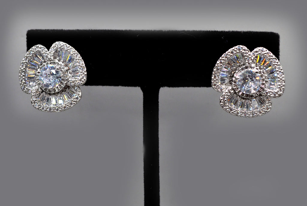 Baguette halo crystal studs featuring round center framed by dimensional baguette-cut stones, product view at Rebecca’s…