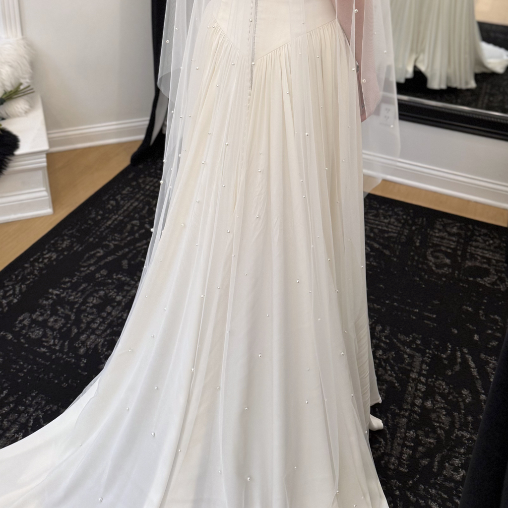 Cathedral-length pearl bridal veil with hand-placed pearls throughout ivory tulle. Modern wedding veil styled with a minimalist wedding gown at Rebecca's Wedding Boutique in Louisville, KY.
