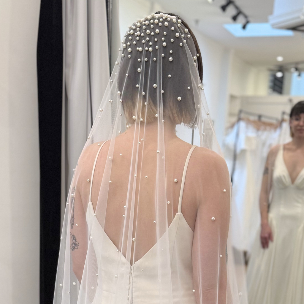 Modern pearl cathedral veil with dimensional pearl embellishments and soft flowing tulle. Bridal veil inspiration for contemporary, minimalist, and romantic wedding day looks.