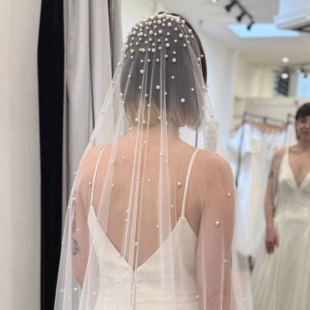 Modern pearl cathedral veil with dimensional pearl embellishments and soft flowing tulle. Bridal veil inspiration for contemporary, minimalist, and romantic wedding day looks.